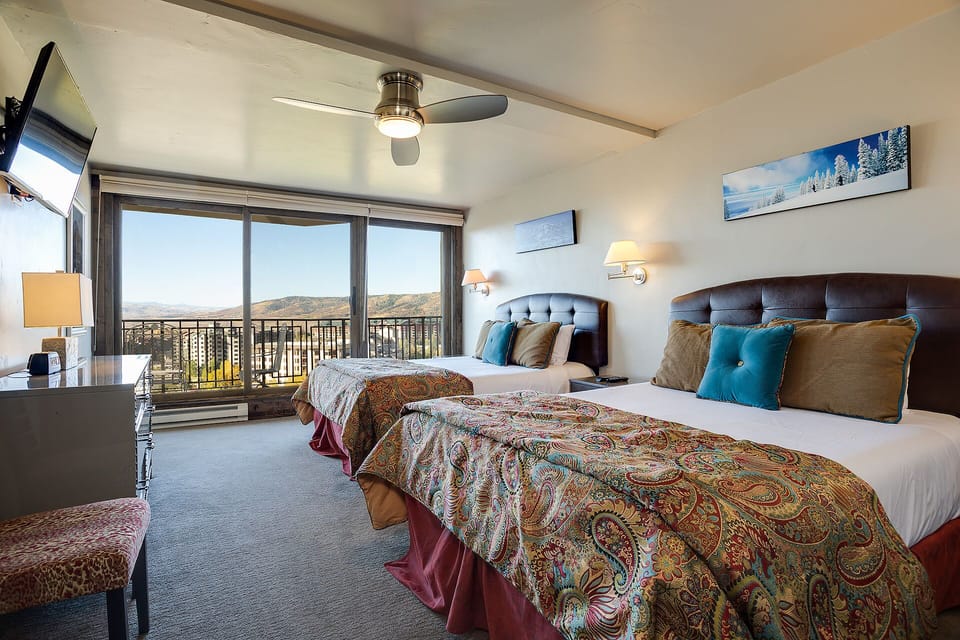Wake up to sweeping mountain vistas from your cozy twin beds, perfectly positioned to capture the breathtaking scenery beyond your private balcony.