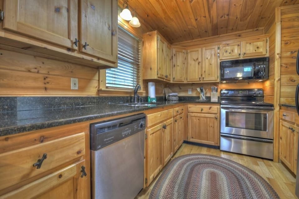 Fully stocked kitchen with granite countertops and stainless steel appliances