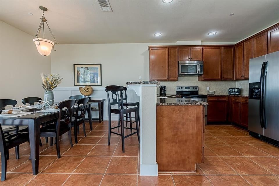 Open kitchen area has an eat at bar counter and all major appliances.