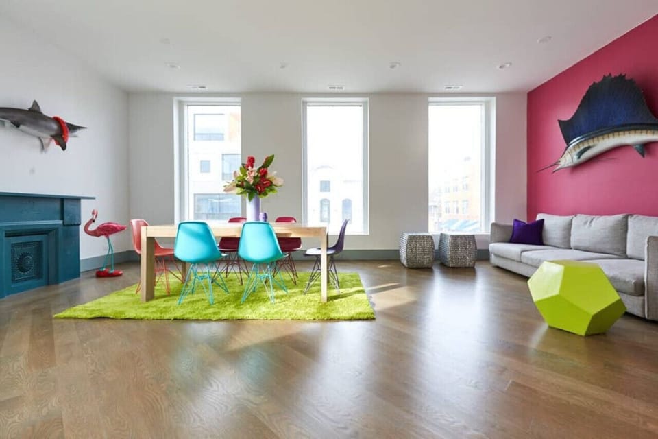 Spacious and colorful open-concept living area with bold decor, large windows, and vibrant design 🎨🪟 Ideal for entertaining, bachelorette parties, or group celebrations!  🤩🎉🥳👰 Natural light and fun vibes throughout!