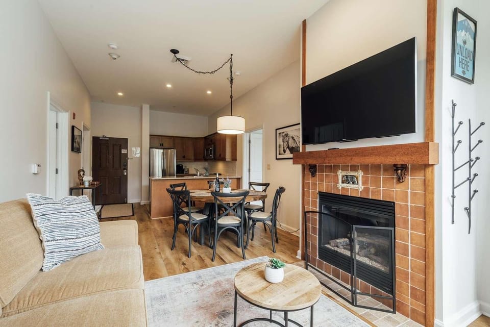 Cozy living room with fireplace and open kitchen dining area