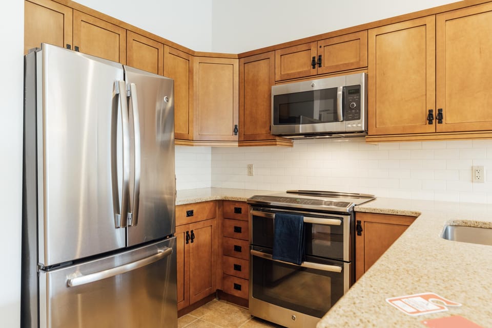 Modern kitchen with stainless steel appliances and granite countertops