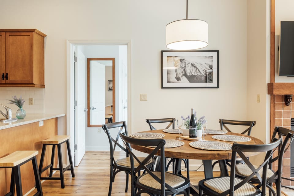Bright dining area with rustic wood table and cozy seating