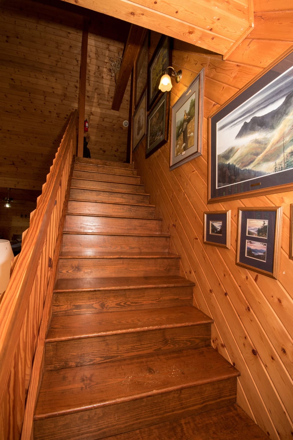 The stairway to the loft features a collection of Jim Gray art of the Smokies.
