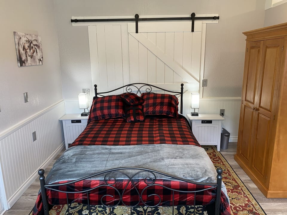 Queen bed with wardrobe for your hanging items and with extra linens.