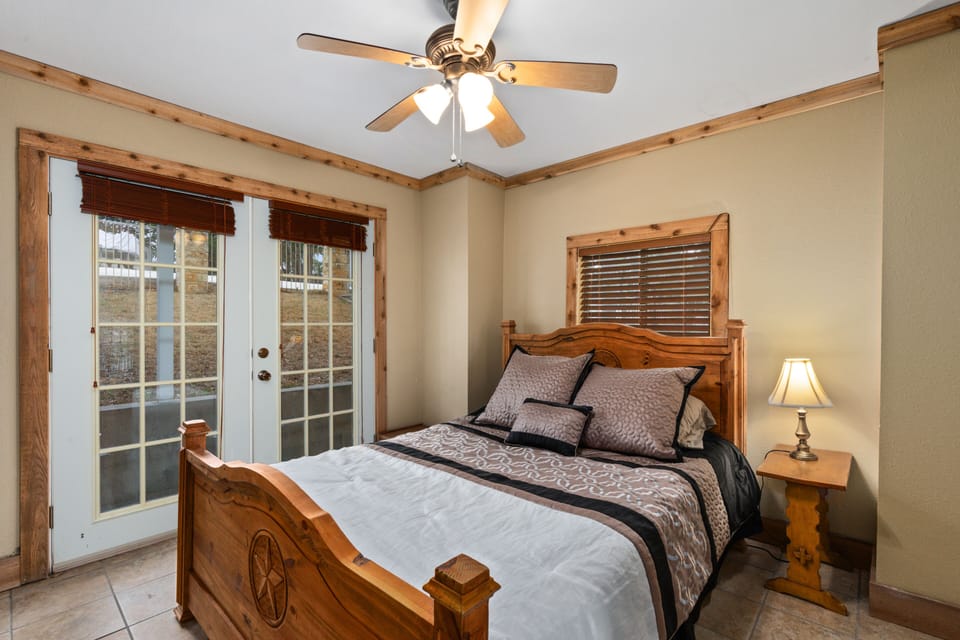 Downstairs queen guest room. French doors to outside front yard. Ceiling fan.