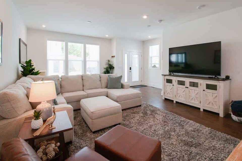 Bright, cozy living space with a smart TV and natural light perfect for relaxing.