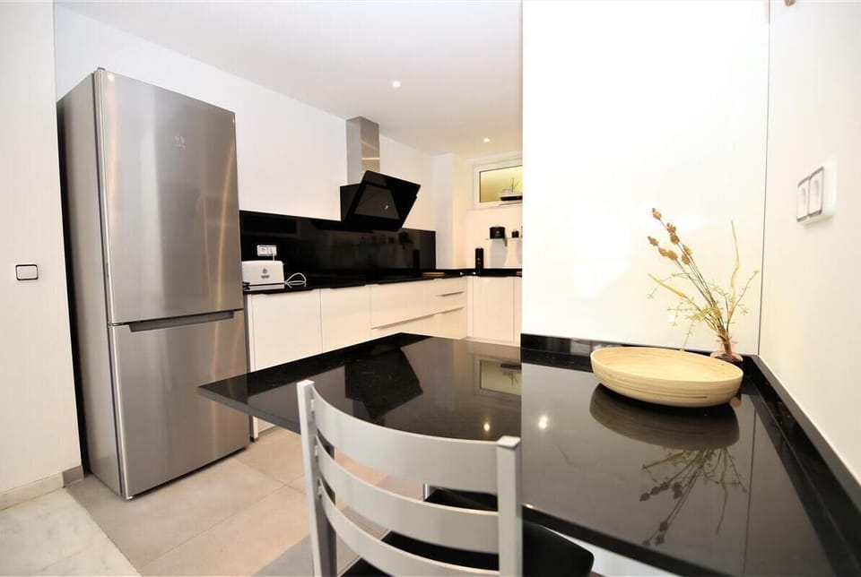 Another view of the modern kitchen from the breakfast bar