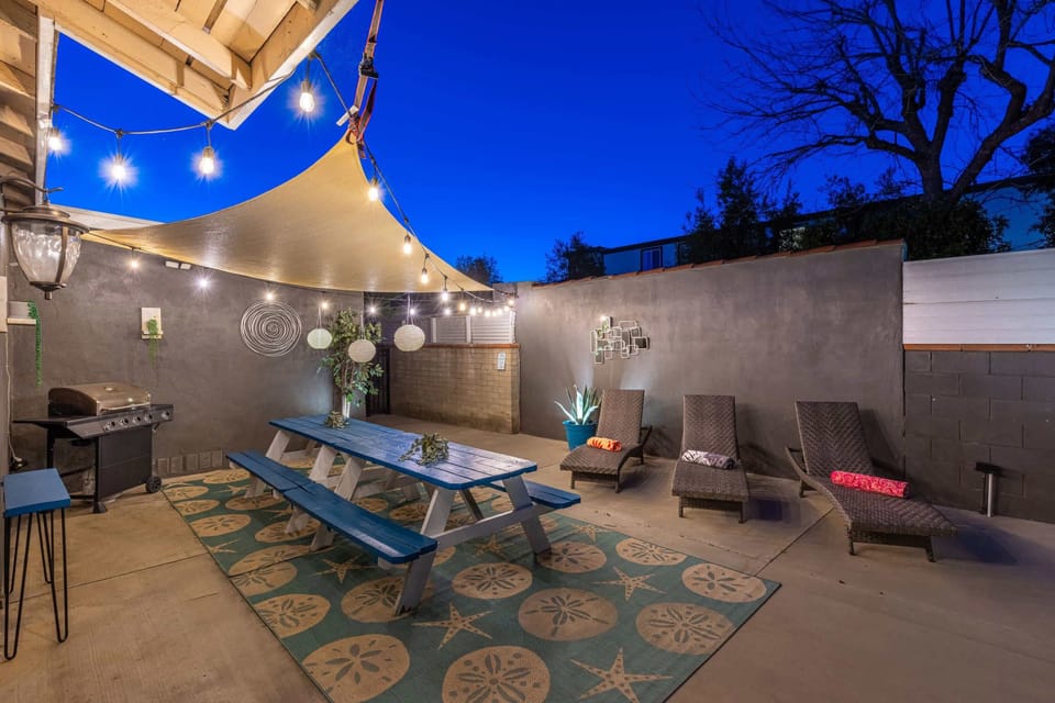 Amazing outdoor space, large dining table with beautiful night lighting as well