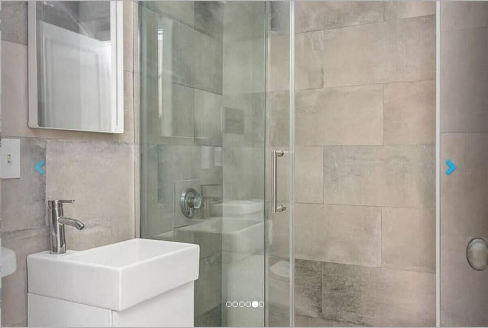 The recently renovated bathroom has a stand up shower.