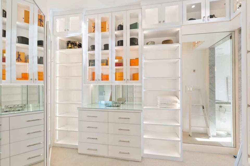 Spacious walk-in closet with full length mirrors.