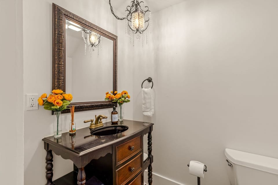 Elegant powder room featuring vintage-inspired furnishings and sophisticated finishes.