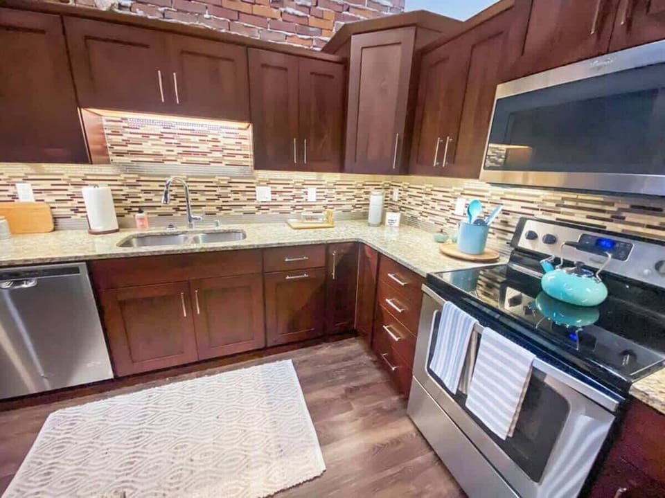 Granite countertops, stove, microwave, dishwasher, refrigerator , and freezer with ice maker. All the dishes, pots, pans, barware and more that's needed in a kitchen. 
