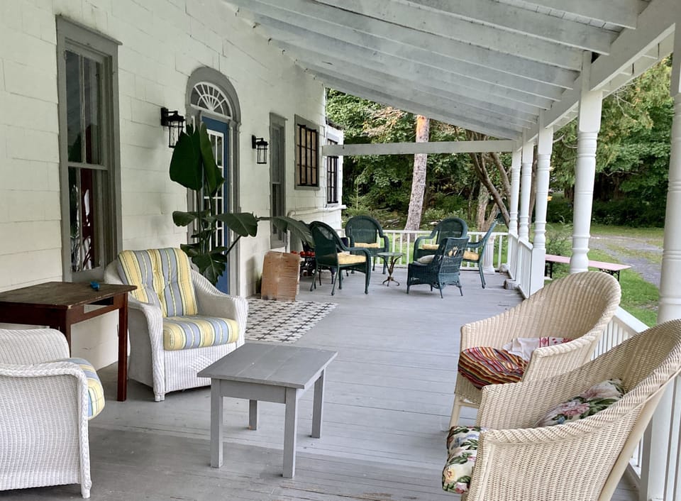 The huge porch wraps around three sides of the house.