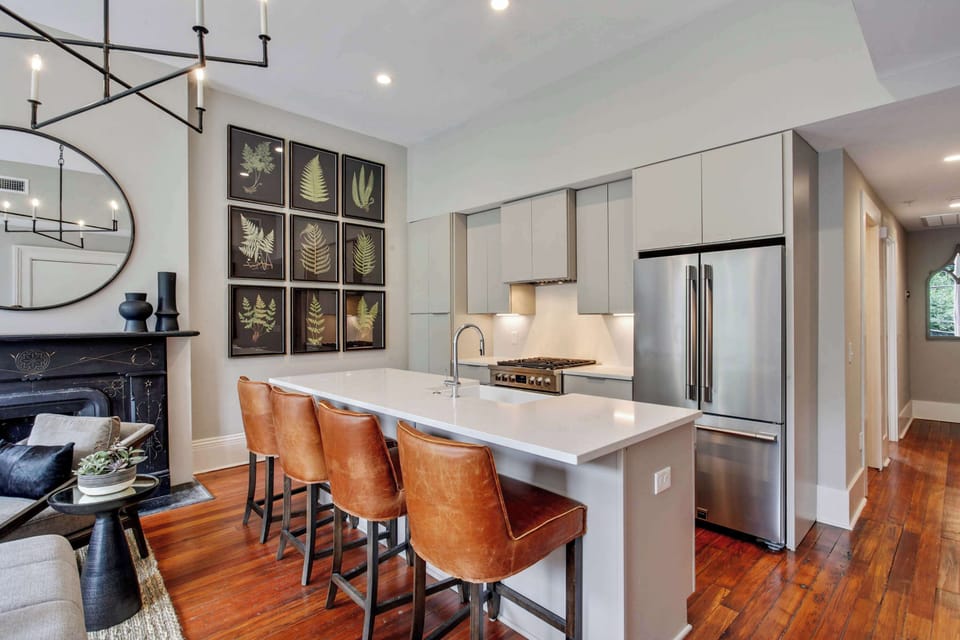  Kitchen | Open Concept Kitchen with Island and Bar Seating | Third Floor of Building — Unit on One Level