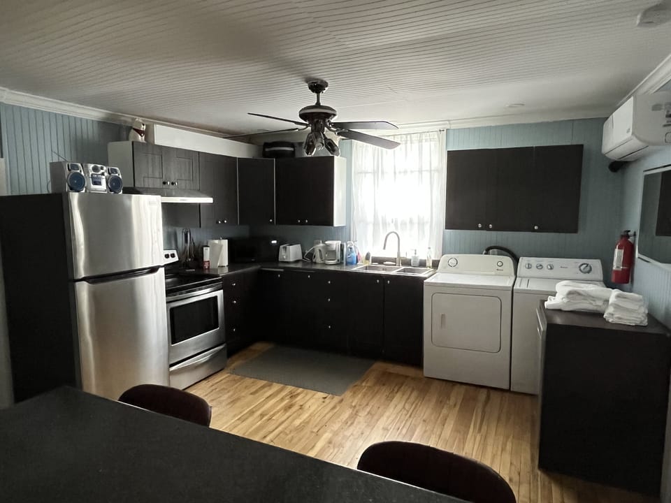 Kitchen with fridge, stove and microwave
