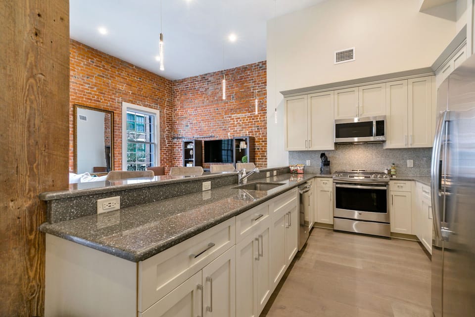Cook and dine easily in the fully stocked kitchen, equipped with all stainless steel appliances, gas range, basic cookware, and a dining area for a comfortable meal at home. Entertain at the bar with seating for four.