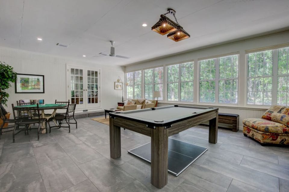 Game room with a pingpong/pool table, board games, Pacman & a poker table + more