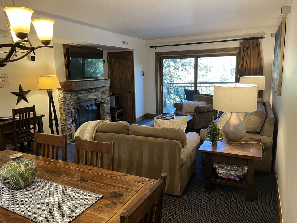 Wood fireplace, large smart TV with surround sound, and courtyard balcony