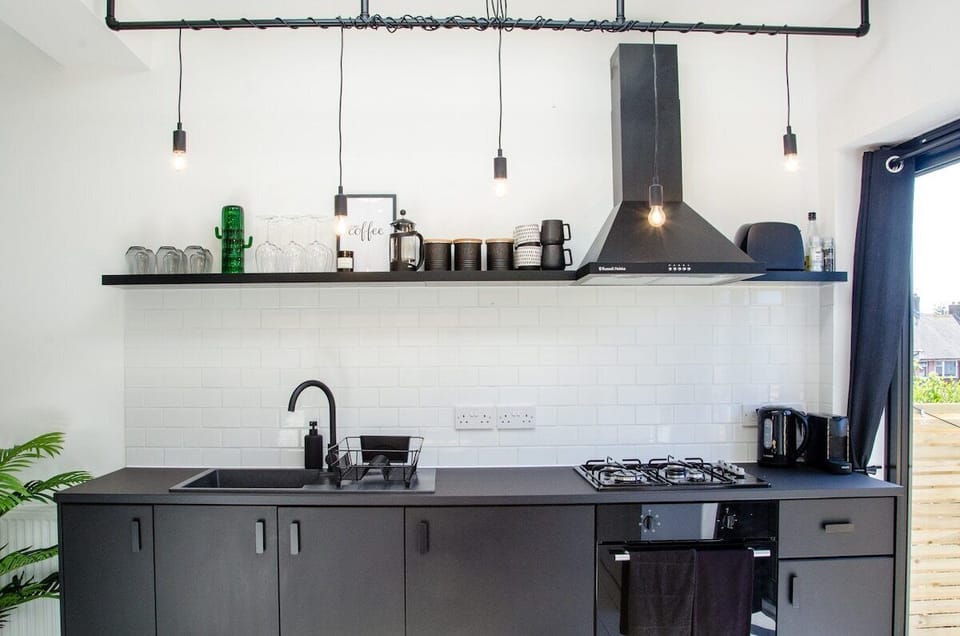 Modern aesthetics meet cleanliness in our stylish black-themed kitchen.
