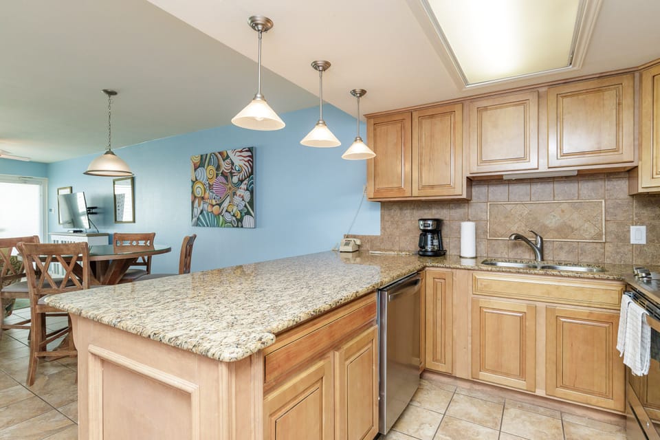 Your open kitchen features granite countertops and warm wood cabinets, perfect for preparing meals with natural light streaming in.