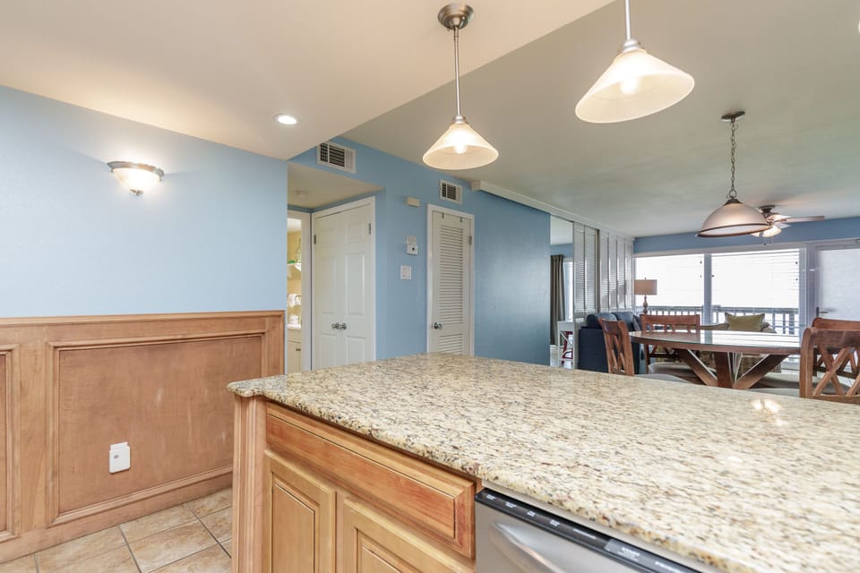 Gather around this spacious granite-topped island where your morning coffee and evening conversations will unfold naturally in this open-concept living space.