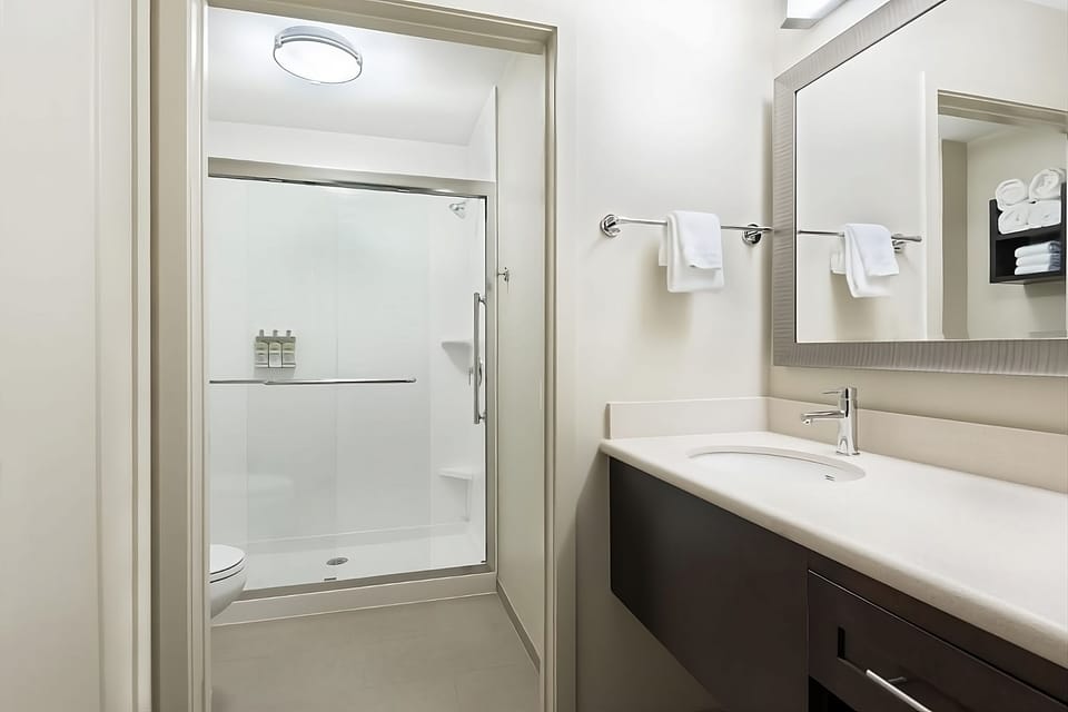 Refresh in a sleek, spa-like bathroom with glass shower.