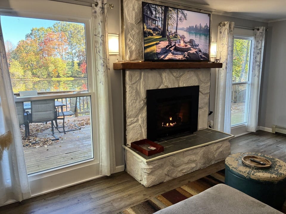 Enjoy lake views, the fireplace, and your favorite shows in the cozy living room