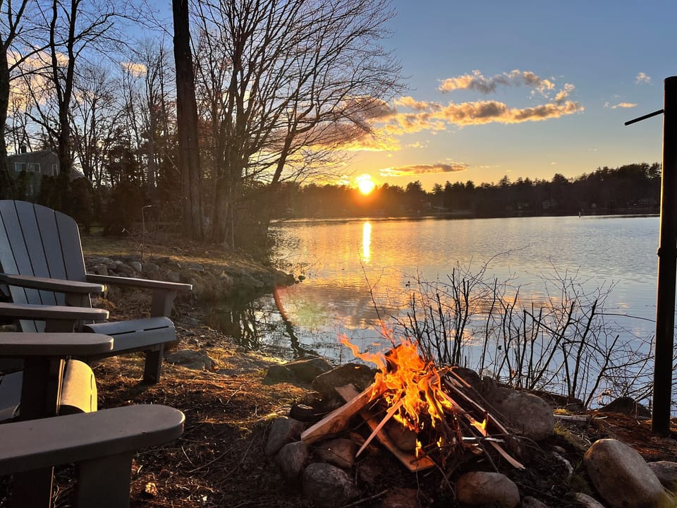 Sunset and camp fire by the water