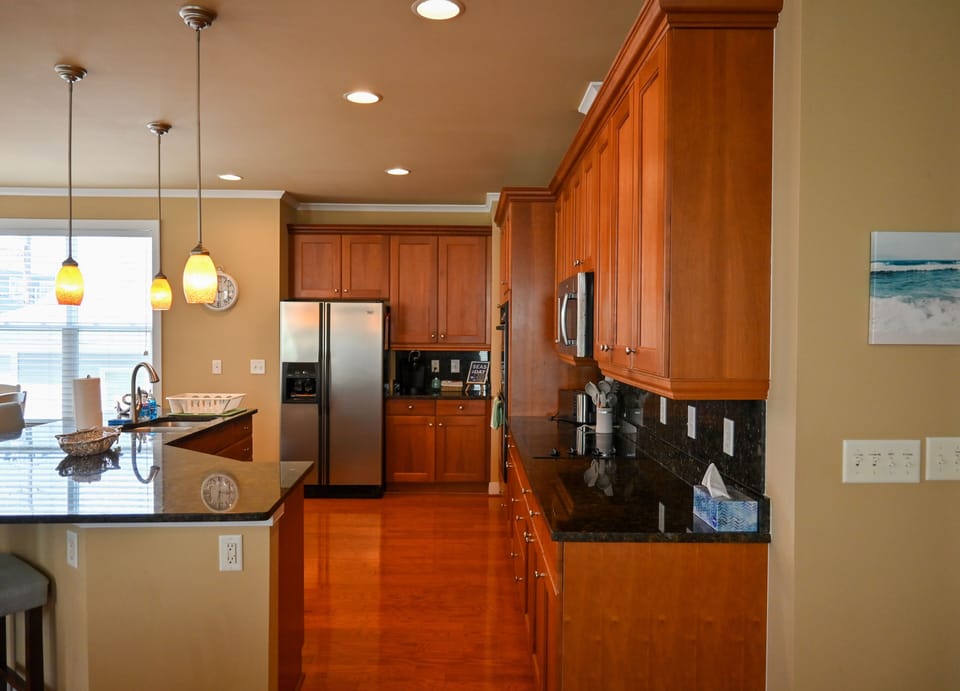 Kitchen views w/ microwave, dishwasher, + double ovens.
