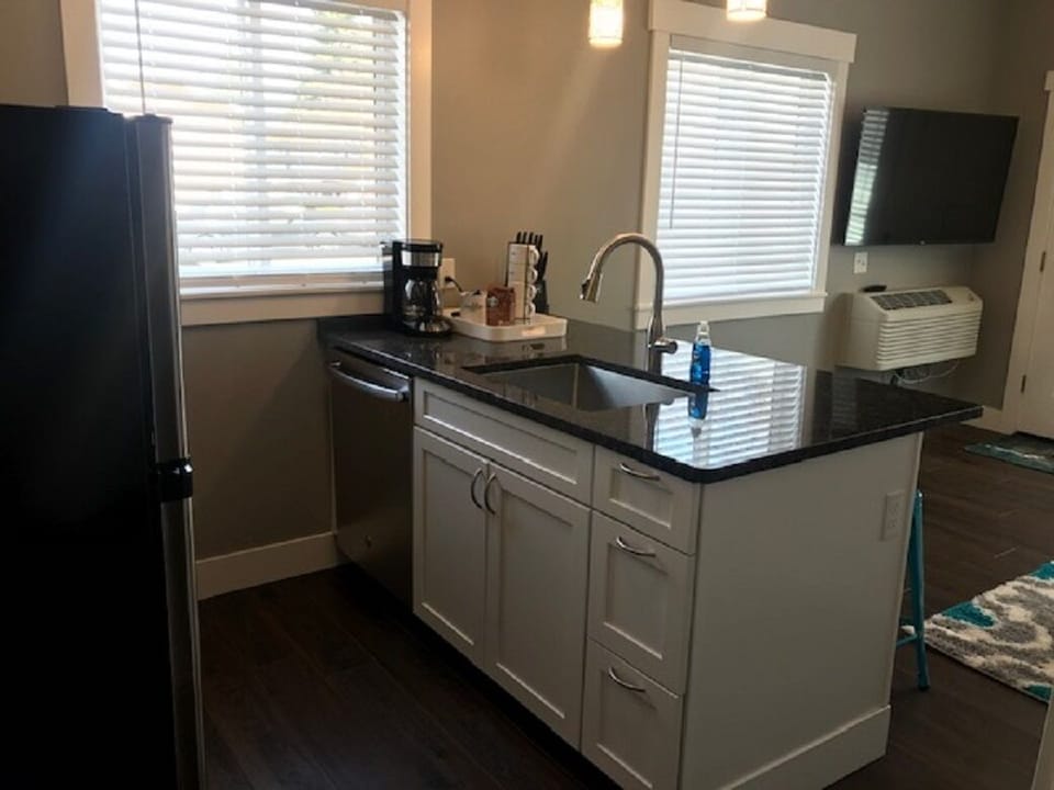 Dishwasher in island.  Coffee pot with provided coffee
