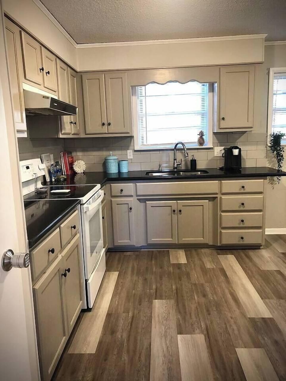 Bright kitchen with cookware and full size appliances