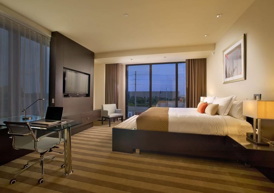 Settle into a spacious room with calming evening glow.