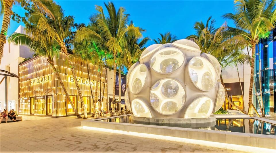 Arrive to a glamorous, palm-lined entrance glowing at dusk.