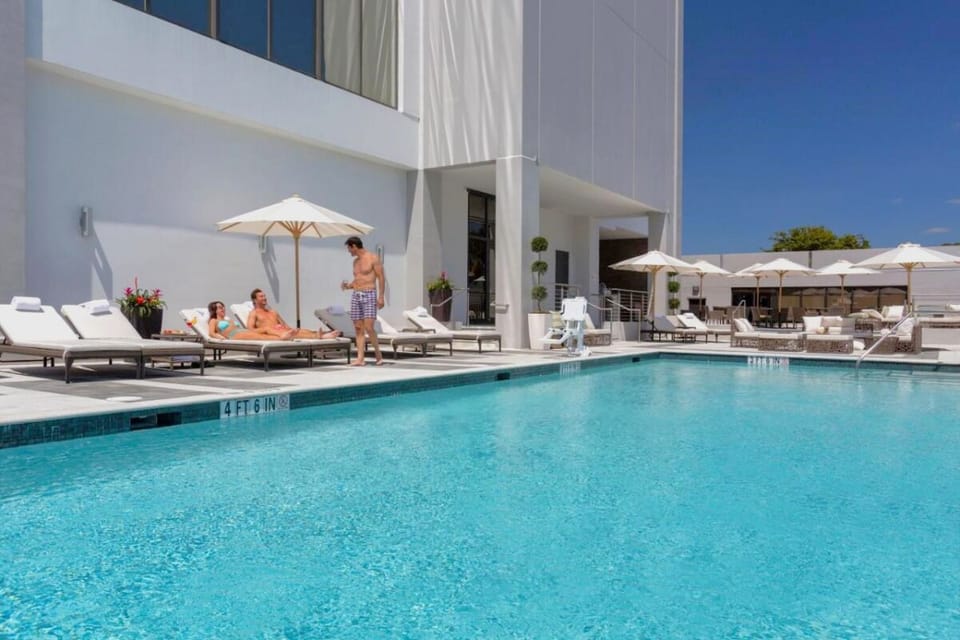 Soak up the sun with spacious loungers beside sparkling water.