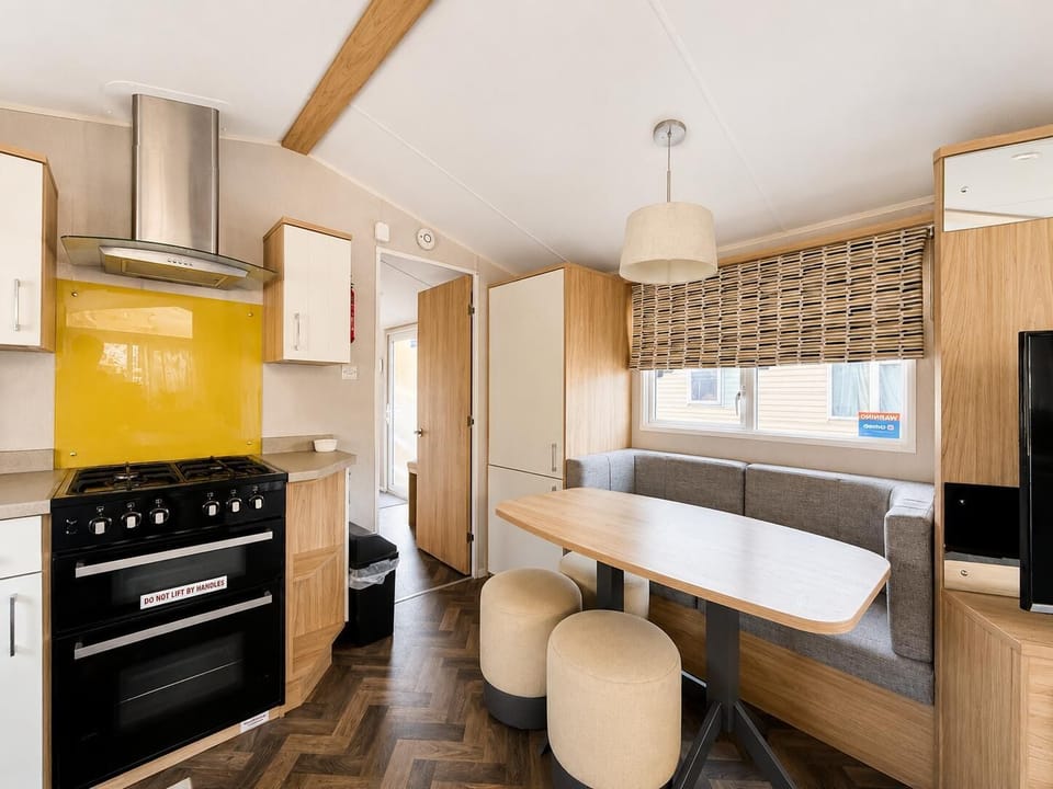 Dining area with cushioned corner seating, perfect for family dinining in this spacious holiday home.