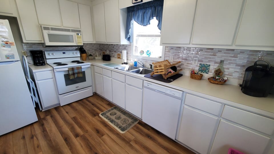 The kitchen features new fridge, stove, dishwasher, and much of what you'll need