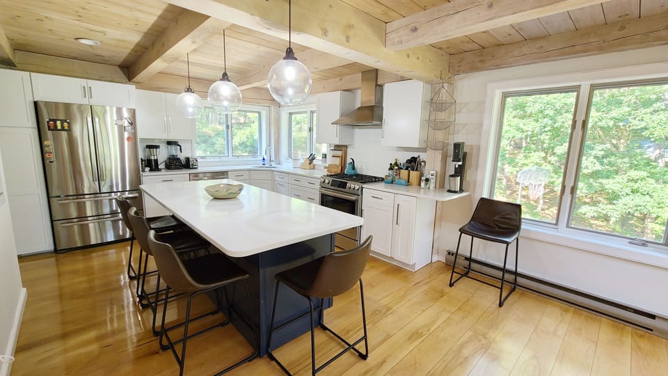 Kitchen has an island and stainless appliances