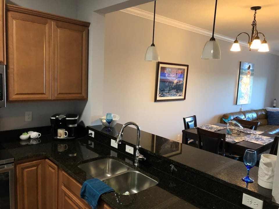 Looking out from kitchen. The counter has barstools