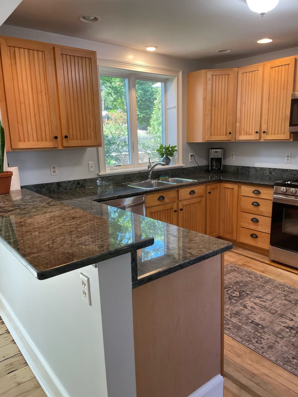 Large chef kitchen with granite and stainless steel appliances. 