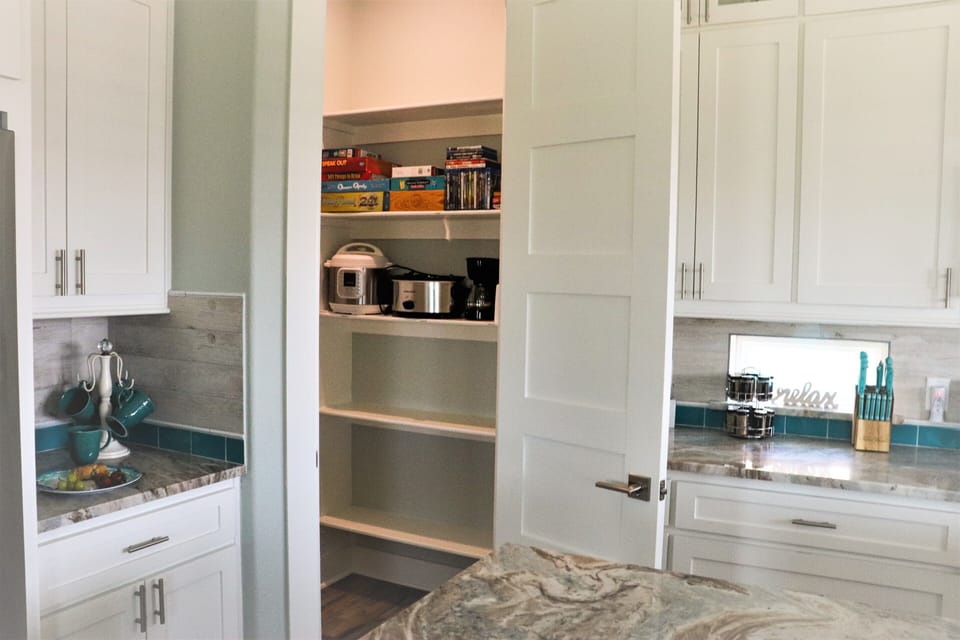 Large Pantry with Instant Pot, Crock pot, extra coffee pot, Games, and DVD's.