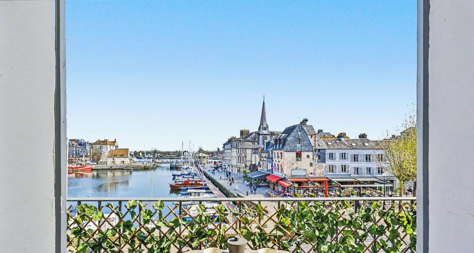 Enjoy breakfast on the balcony, watching the sailboats and lively port