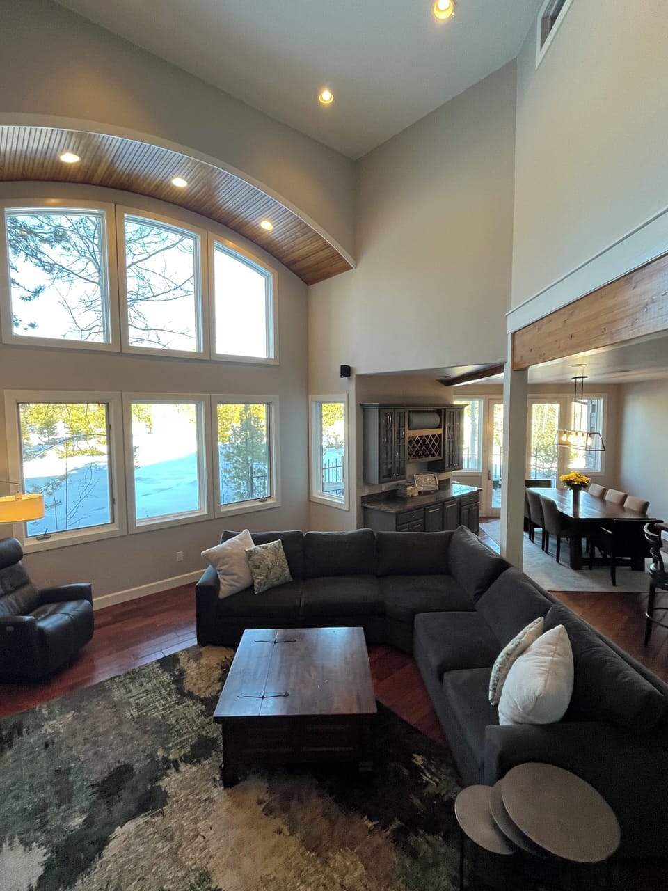The two story great room feels open and airy with ample views of the outdoors