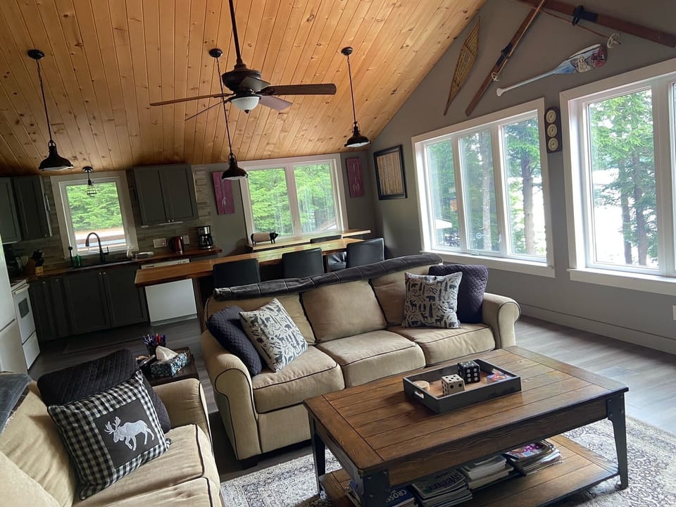 Open concept main floor living room and fully-equipped kitchen.
