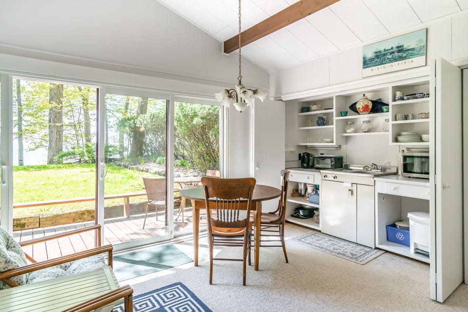 Guest house kitchenette with fridge, small stove, sink, microwave & coffee maker