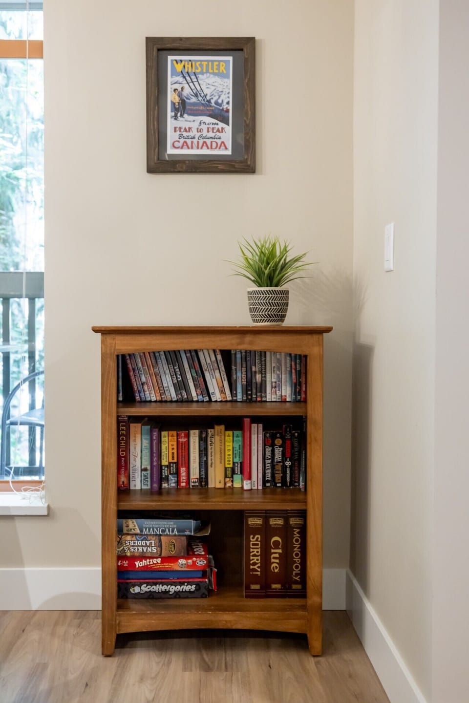 Thoughtfully styled bookshelf with a selection of books and décor, adding warmth and character to the space.