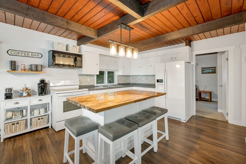 Butcher block island with comfortable stools; new fridge, stove & dishwasher