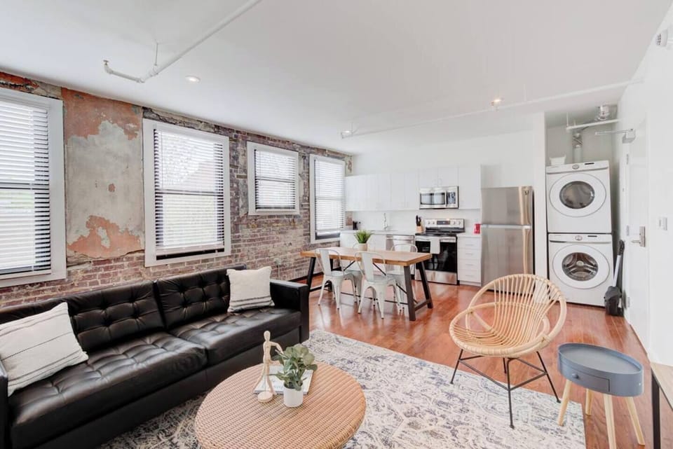 Spacious open-concept living with a fully equipped kitchen, dining area, and convenient laundry, all seamlessly connected for a comfortable, modern experience.