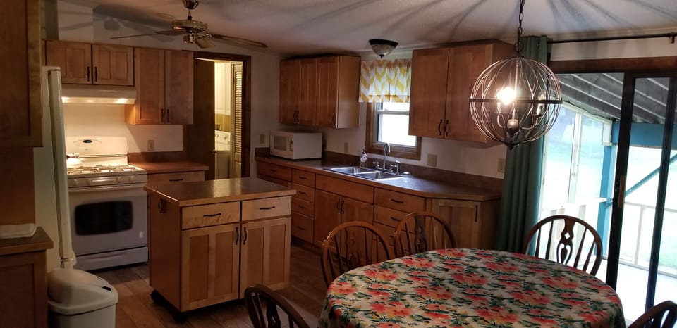 Kitchen and dining area with sliding glass door to screen-enclosed back patio
