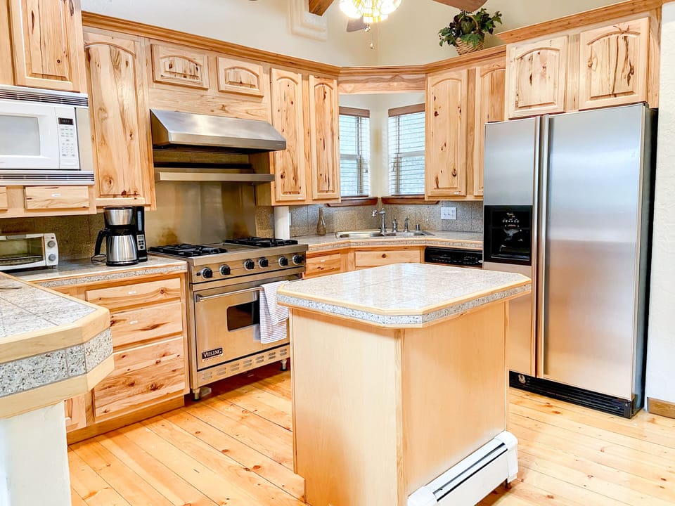 Open and well-stocked kitchen with professional grade Viking stove!
